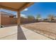 A covered patio overlooks the low maintenance backyard at 1178 E Tyler Ln, Casa Grande, AZ 85122