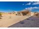 Low-maintenance backyard with gravel, block wall and covered patio at 1178 E Tyler Ln, Casa Grande, AZ 85122