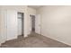 Bedroom featuring double door closet and neutral carpeting at 1178 E Tyler Ln, Casa Grande, AZ 85122