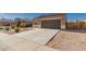 Welcoming single-story home featuring a two-car garage, desert landscaping, and a spacious driveway at 1178 E Tyler Ln, Casa Grande, AZ 85122