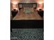 Comfortable bedroom with an elegant bedframe, complementing pillows, bedside lamps, and a patterned rug at 12123 W Bell Rd # 118, Surprise, AZ 85378