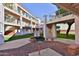 A complex's common area has a grill for residents' use with balconies in the background at 12123 W Bell Rd # 118, Surprise, AZ 85378