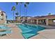 Palm trees line the community pool, with lounge chairs and tables under a covered area at 12123 W Bell Rd # 118, Surprise, AZ 85378