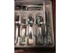 Organized cutlery drawer featuring shining silverware in a compartmentalized plastic tray insert at 12123 W Bell Rd # 118, Surprise, AZ 85378