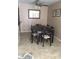 The dining room features a ceiling fan and a black dining table with seating for six at 12123 W Bell Rd # 118, Surprise, AZ 85378