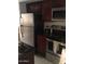 Modern kitchen with stainless steel appliances and dark wood cabinets at 12123 W Bell Rd # 118, Surprise, AZ 85378