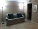 Cozy living room with a comfortable couch and elegant floor lamps at 12123 W Bell Rd # 118, Surprise, AZ 85378