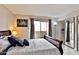 Bright bedroom with a large window, balcony access, and neutral wall color at 12123 W Bell Rd # 218, Surprise, AZ 85378