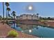 Picturesque exterior view of community buildings reflected in a calm canal under a sunny sky at 12123 W Bell Rd # 218, Surprise, AZ 85378