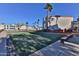 Condo community grounds showing turf and seating areas, landscaped with mature trees and plants at 12123 W Bell Rd # 218, Surprise, AZ 85378