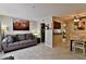 Inviting living room featuring a comfortable couch, artwork, and tile flooring at 12123 W Bell Rd # 218, Surprise, AZ 85378