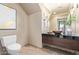 Bright bathroom with black granite counter and travertine floors at 12625 N Saguaro Blvd # 203, Fountain Hills, AZ 85268