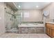 Beautiful bathroom featuring separate shower and tub with travertine tile at 12625 N Saguaro Blvd # 203, Fountain Hills, AZ 85268