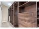 Large, walk-in closet with custom wood shelving and drawers at 12625 N Saguaro Blvd # 203, Fountain Hills, AZ 85268