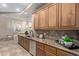 Kitchen with granite countertops, wood cabinetry and stainless appliances, adjacent to dining area at 12625 N Saguaro Blvd # 203, Fountain Hills, AZ 85268