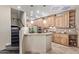 Warm kitchen featuring wood cabinets, granite countertops, and stainless steel appliances at 12625 N Saguaro Blvd # 203, Fountain Hills, AZ 85268