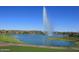 Picturesque lake view showcasing a water fountain with the community and desert mountains in the background at 12625 N Saguaro Blvd # 203, Fountain Hills, AZ 85268