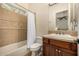 Small bathroom with a bathtub and shower combo, plus tile walls and a vanity with drawers at 13207 W Santa Ynez Dr, Sun City West, AZ 85375