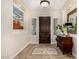 Inviting foyer with mosaic tile floor, dark wood door, and stylish decor at 13207 W Santa Ynez Dr, Sun City West, AZ 85375