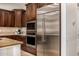 Kitchen includes stainless steel appliances and dark wood cabinets for a luxurious feel at 13207 W Santa Ynez Dr, Sun City West, AZ 85375