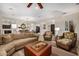 Spacious living room featuring a fireplace, comfortable seating, and views to the dining area at 13207 W Santa Ynez Dr, Sun City West, AZ 85375