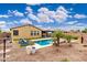 Aerial view of the backyard featuring a pool, patio, putting green, mature landscaping and lounge seating at 14906 W Luna N Dr, Litchfield Park, AZ 85340