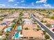 View of neighborhood featuring pools, mature landscaping, and easy access to community road at 14906 W Luna N Dr, Litchfield Park, AZ 85340