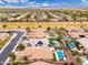 Residential area with green spaces, pools, and easy access to a community road at 14906 W Luna N Dr, Litchfield Park, AZ 85340