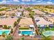 Beautiful backyard with swimming pool, green turf, desert landscaping, and a covered patio at 14906 W Luna N Dr, Litchfield Park, AZ 85340