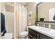 Neutral bathroom featuring a single vanity, decorative mirror, and a shower/tub combination at 14906 W Luna N Dr, Litchfield Park, AZ 85340