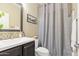 Cozy bathroom featuring a single sink vanity, patterned tiling, and a shower/tub combination at 14906 W Luna N Dr, Litchfield Park, AZ 85340