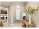 Welcoming entryway featuring tile floors, neutral walls, and a view of the laundry room at 14906 W Luna N Dr, Litchfield Park, AZ 85340
