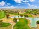 Aerial view of a pristine golf course with a water feature, lush greenery and blue sky at 14906 W Luna N Dr, Litchfield Park, AZ 85340