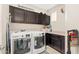 Laundry room with front-load washer and dryer and upper cabinets at 14906 W Luna N Dr, Litchfield Park, AZ 85340