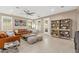 Inviting living room with tile floors, a ceiling fan, and plenty of natural light at 14906 W Luna N Dr, Litchfield Park, AZ 85340