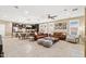 Open concept living space featuring tile floors, modern furnishings, and seamless flow between the kitchen and living room at 14906 W Luna N Dr, Litchfield Park, AZ 85340