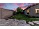 Private backyard with mature landscaping, lush green lawn, and flagstone patio, perfect for relaxation and entertaining at 1528 E Harrison St, Gilbert, AZ 85295