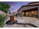 Inviting backyard featuring a custom BBQ island, cozy outdoor seating, water feature and mature desert landscaping at 1528 E Harrison St, Gilbert, AZ 85295