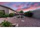 Inviting backyard featuring low maintenance landscaping, lush plants, a brick pathway, and desert sunset views at 1528 E Harrison St, Gilbert, AZ 85295