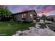 Beautiful backyard with lush green lawn, stone walkway, desert landscaping, and great exterior views at 1528 E Harrison St, Gilbert, AZ 85295