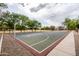 Community basketball court surrounded by mature trees, ideal for recreation and friendly games with neighbors at 1528 E Harrison St, Gilbert, AZ 85295