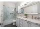 Stylish bathroom featuring a marble shower, dual sink vanity, and modern fixtures, offering a spa-like experience at 1528 E Harrison St, Gilbert, AZ 85295