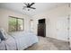 Bright bedroom includes a ceiling fan, carpet, and an outdoor access door at 1528 E Harrison St, Gilbert, AZ 85295