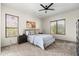 Comfortable bedroom with a ceiling fan, neutral tones, and ample natural light at 1528 E Harrison St, Gilbert, AZ 85295