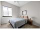 Cozy bedroom featuring neutral walls, carpeted floors, ceiling fan and large window at 1528 E Harrison St, Gilbert, AZ 85295