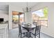 Eat-in kitchen with backyard views, modern chandelier, and neutral-toned furniture at 1528 E Harrison St, Gilbert, AZ 85295