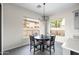 Dining area features a modern chandelier, large windows, and comfortable seating at 1528 E Harrison St, Gilbert, AZ 85295