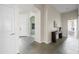 Welcoming foyer featuring stone tile flooring and views into other rooms of the home at 1528 E Harrison St, Gilbert, AZ 85295