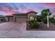 Charming home with three-car garage and landscaped front yard under a dramatic sunset sky at 1528 E Harrison St, Gilbert, AZ 85295