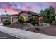 Attractive home with well-maintained landscaping and a three-car garage against a vibrant sunset backdrop at 1528 E Harrison St, Gilbert, AZ 85295